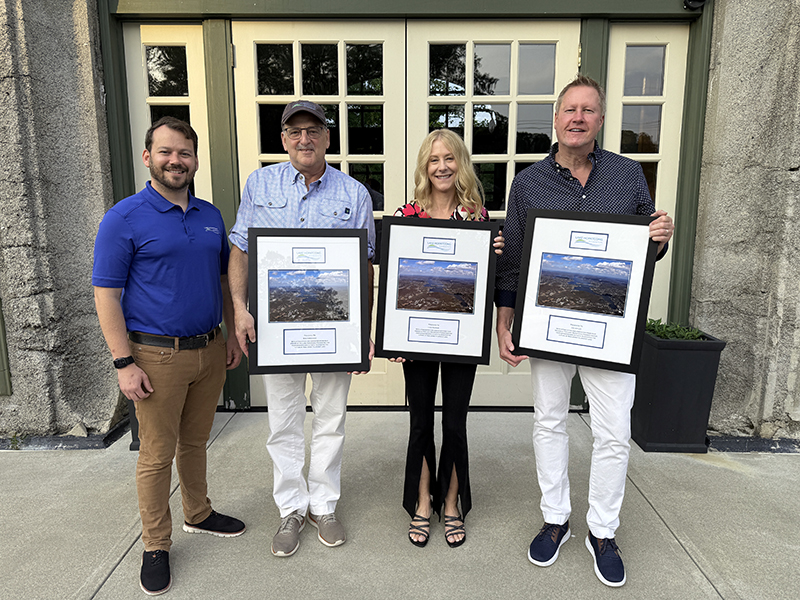 Executive Director Kyle Richter stands with the 2025 Annual Meeting Honorees.