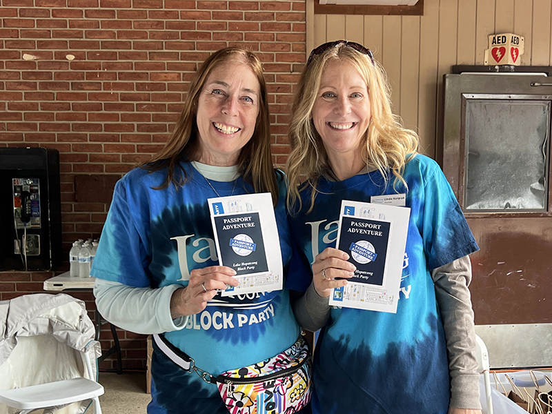 Volunteers hand out Passport Adventure booklets
